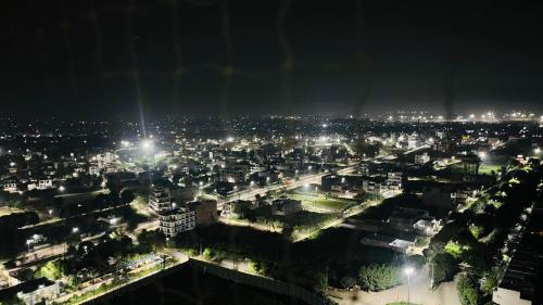 a view of a city at night with lights at Isha Homes in Greater Noida