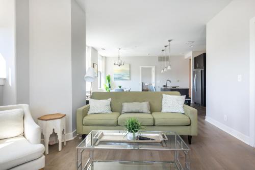 a living room with a couch and a table at 2B 2BA Luxury Downtown Suite Rooftop Deck & Gym in Baltimore
