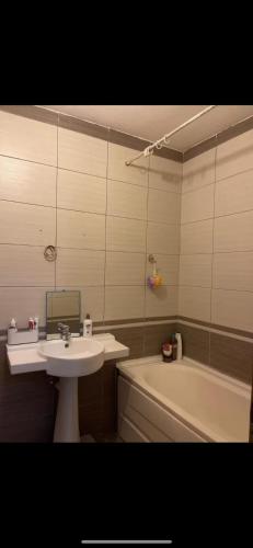 a bathroom with a sink and a bath tub at IdealHasani in Kosovo Polje