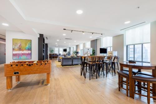 a living room with a pool table and chairs at 2B 2BA Luxury Downtown Suite Rooftop Deck & Gym in Baltimore