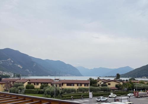 a view of a town with mountains and a body of water at Lake & More Suite Hotel in Paratico