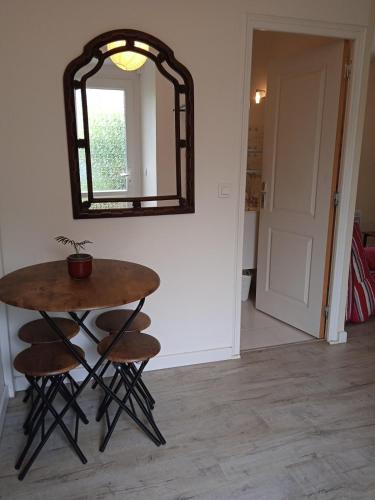 a table and stools in a room with a mirror at Gite a Firmi in Firmi