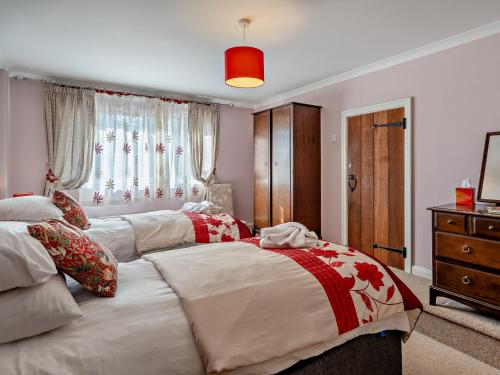 a bedroom with two beds and a dresser at 5 Bed in Newton-in-Cartmel 95876 in High Newton