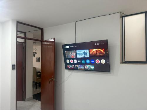 a flat screen tv on the wall of a room at Casa de Stephano in Lima