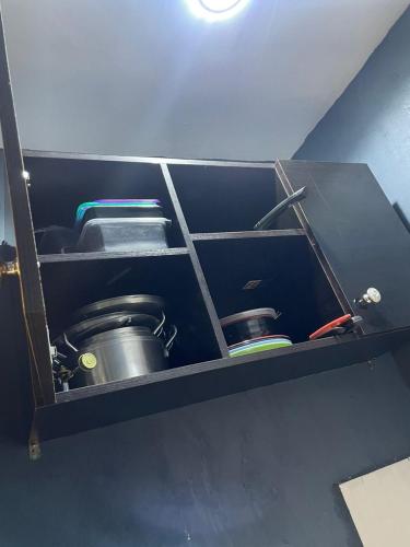 a shelf with two pots and pans in a room at Soma Homes in Lagos