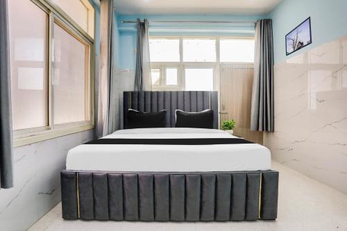 a large bed in a room with a window at Hotel O Safe & Sure Residency in Gurgaon