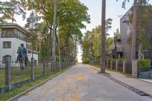 a statue of a man on a horse on a street at Cozy Dzintaru apartment - Steps from Forest and Sea in Jūrmala