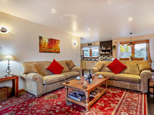 a living room with two couches and a table at 3 Bed in Grantown on Spey 94514 in Grantown on Spey