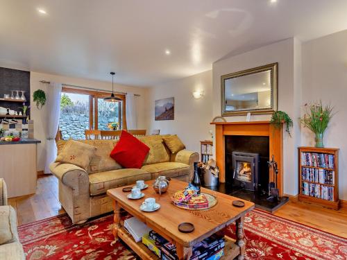 a living room with a couch and a fireplace at 3 Bed in Grantown on Spey 94514 in Grantown on Spey