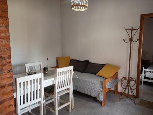 a bedroom with a bed and a table and chairs at Quinta El Cholito in Luján