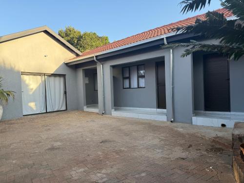a house with a driveway in front of it at Horizon Bed and Breakfast in Roodepoort