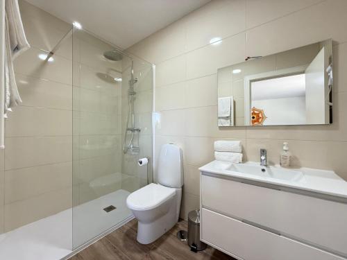 a bathroom with a toilet and a sink and a shower at Suites de Braga in Braga