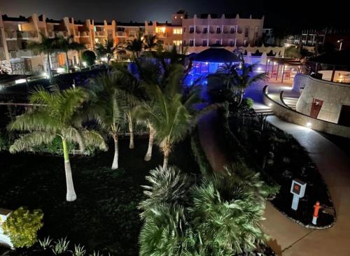 an aerial view of a resort at night with palm trees at Tropical Resort Pool View - Three Bedroom in Santa Maria