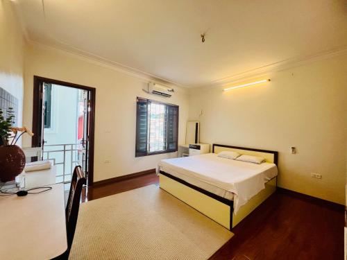 a bedroom with a bed and a balcony at HnHome54AC in Hanoi