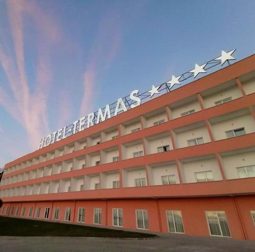 a hotel with a sign on top of a building at Palace Hotel & SPA Termas do Bicanho in Soure