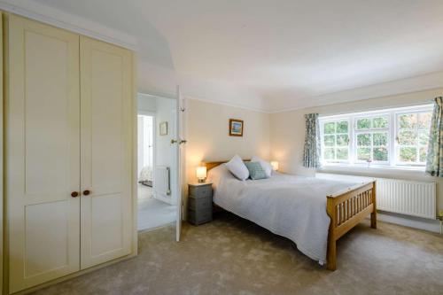 a bedroom with a bed and a large window at Rose Cottage - West Runton in West Runton