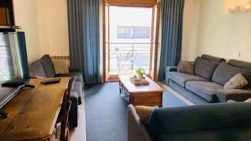 a living room with a couch and a table at Superb flat in the centre of capital, ski, Caldea in Andorra la Vella