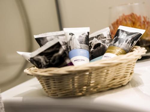 a basket of beauty products sitting on a table at Mercure Hotel Frankfurt Eschborn Ost in Eschborn