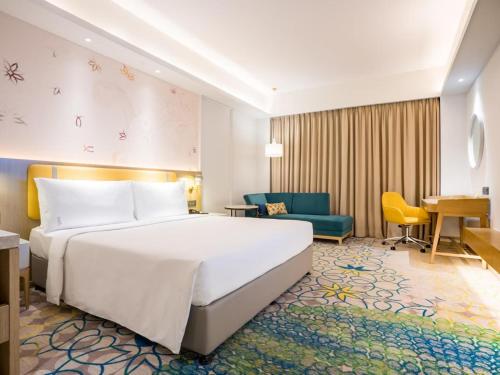 a hotel room with a bed and a desk at Hotel NYASHA Ox Suites Near Delhi Airport in New Delhi
