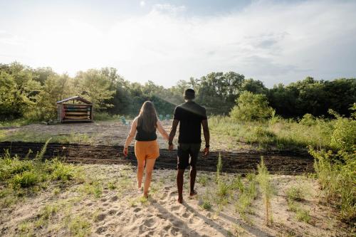 a man and a woman walking down a dirt road at Sonlit Retreats in Skyline