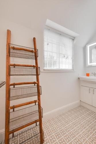 a kitchen with a wooden ladder in a room at Cuckoo Lodge in Wighton