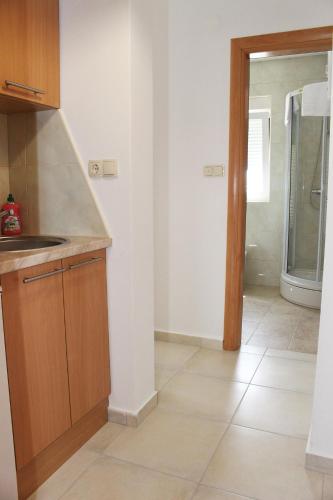 a kitchen with a sink and a counter top at Apartments Bella in Vodice