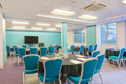 a conference room with a table and chairs and a tv at Atlantic Tower Liverpool City Center By Dancenter in Liverpool