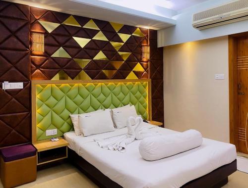 a bedroom with a large bed with a colorful wall at Hotel Beach Way in Cox's Bazar
