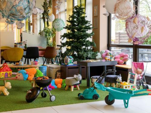 a room filled with toys and a christmas tree at Novotel Nürnberg am Messezentrum in Nürnberg