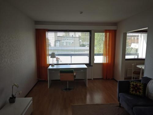 a living room with a desk in front of a window at Peaceful apartment in Finby