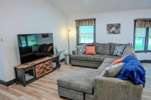 a living room with two couches and a fireplace at Whiskey Trails Getaway in McMinnville