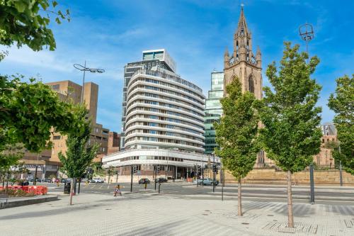 a large building in a city with a clock tower at Atlantic Tower Liverpool City Center By Dancenter in Liverpool