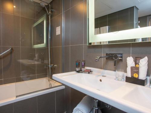 a bathroom with a sink and a shower at Novotel Cairo Airport in Cairo