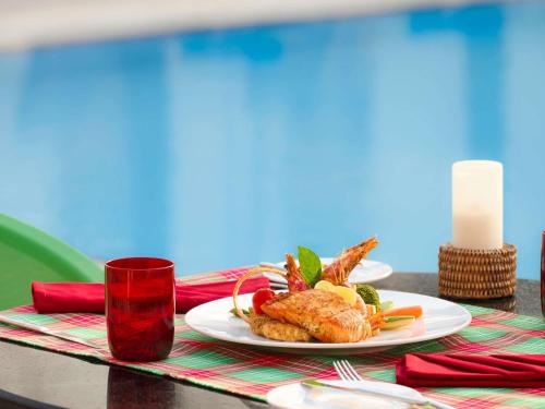 a plate of food with shrimp on a table at Novotel Cairo Airport in Cairo