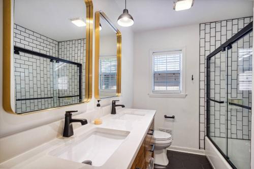 a bathroom with a sink and a toilet and a mirror at The Graham Escape - Memphis Vibe in Memphis