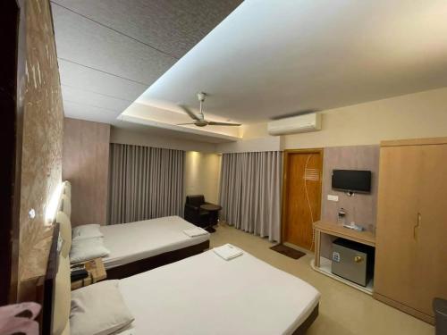 a hotel room with a bed and a tv at Hotel Beach Way in Cox's Bazar