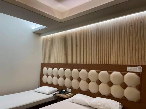 a bedroom with two beds and a head board at Hotel Beach Way in Cox's Bazar