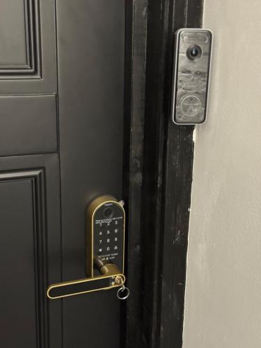 a doorhandle with a key control on a door at Marble Black Suite in Gloucestershire