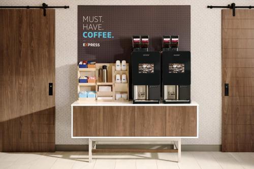 a coffee shop with a counter with a coffee maker at Holiday Inn Express & Suites Tumwater - Olympia by IHG in Tumwater
