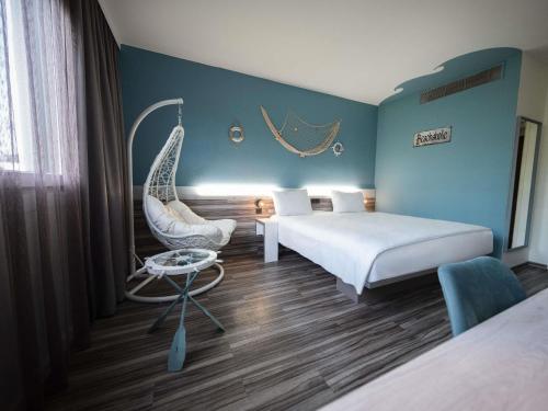 a hotel room with two beds and a swing at Ibis Styles Linz in Linz
