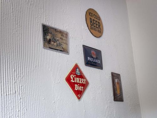 a wall with signs hanging on a white wall at Ibis Styles Linz in Linz