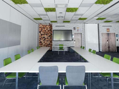 a conference room with a long table and chairs at Ibis Styles Linz in Linz
