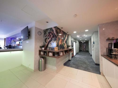 a hallway in a building with paintings on the walls at Ibis Styles Linz in Linz