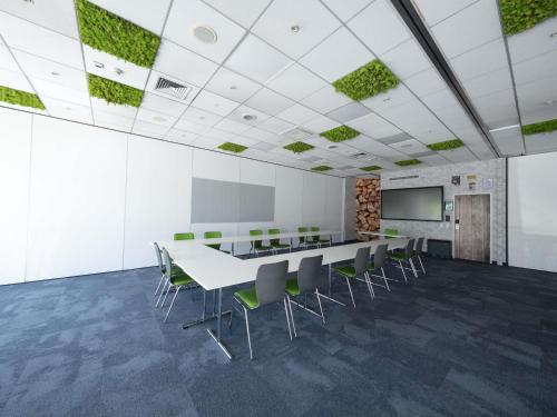 an office with a conference room with a table and chairs at Ibis Styles Linz in Linz