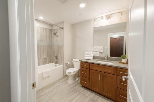 a bathroom with a sink toilet and a mirror at Stylish Luxe Suite Rock Hall, Stadiums, Casino in Cleveland
