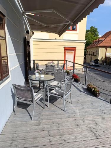 a patio with a table and chairs on a deck at Hotel Salamander - Garni in Banská Štiavnica