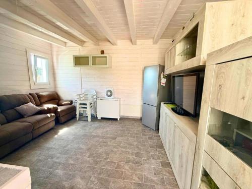a living room with a couch and a table at Azure Oasis with parking near the airport & beach in Focene