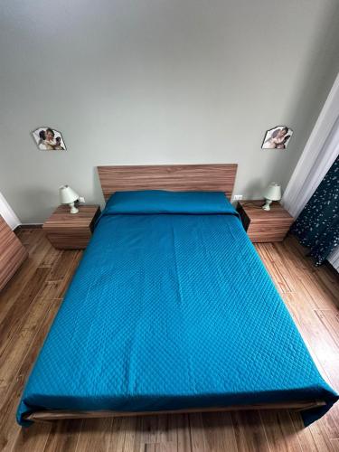 a bed in a room with a blue bedspread at Casa vacanze da Piera di Carta Giuseppina in Sassari