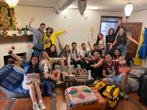 a group of people sitting in a living room at Hostal La Isla in San Cristóbal de Las Casas