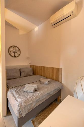 a bedroom with a bed with two towels on it at Jazzy Garden Apartment Komárno in Komárno